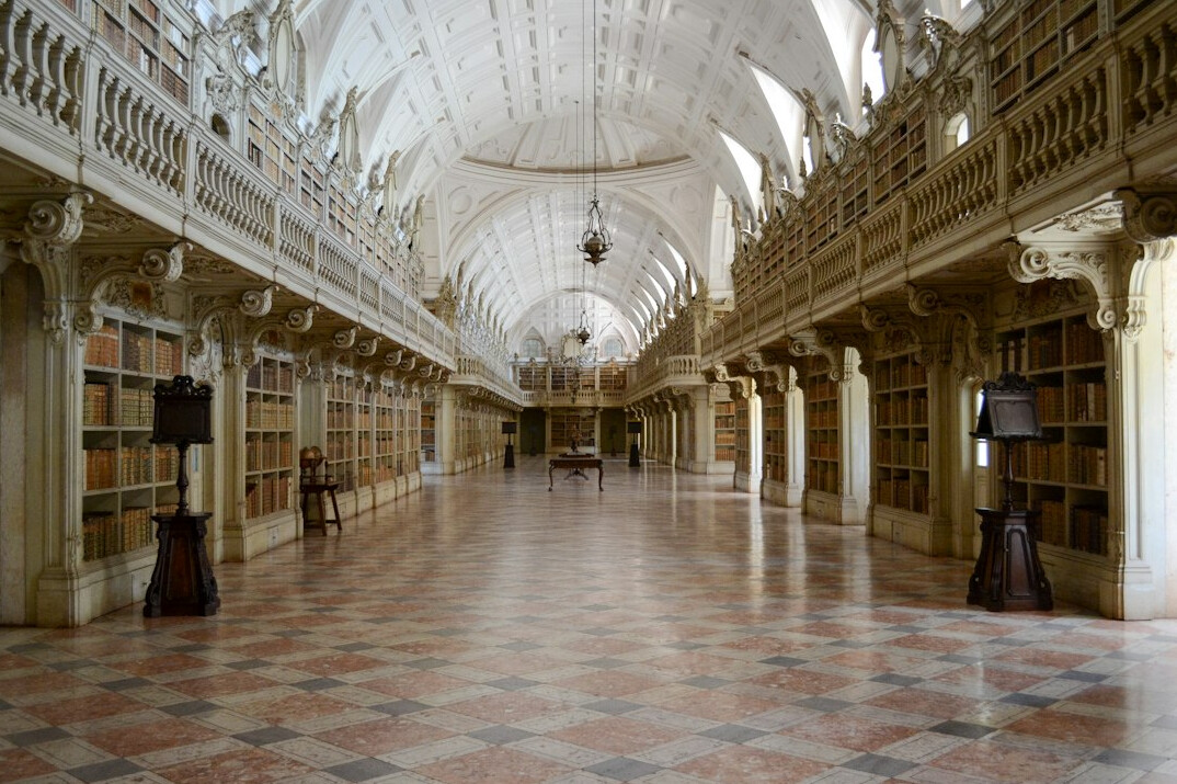 Grand library hall with arched ceilings and bookshelves
