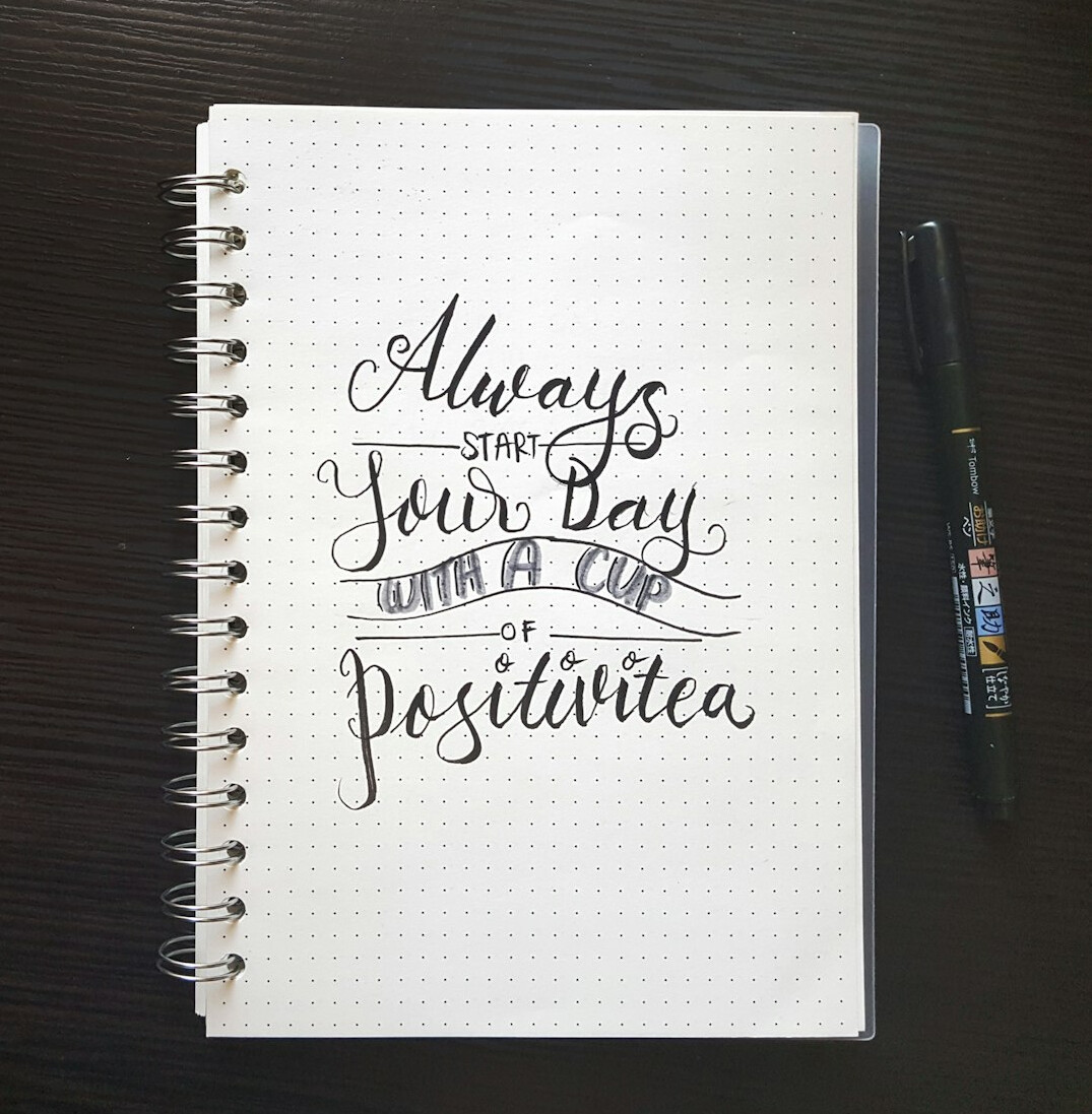 Notebook with handwritten notes and a pen on a wooden desk